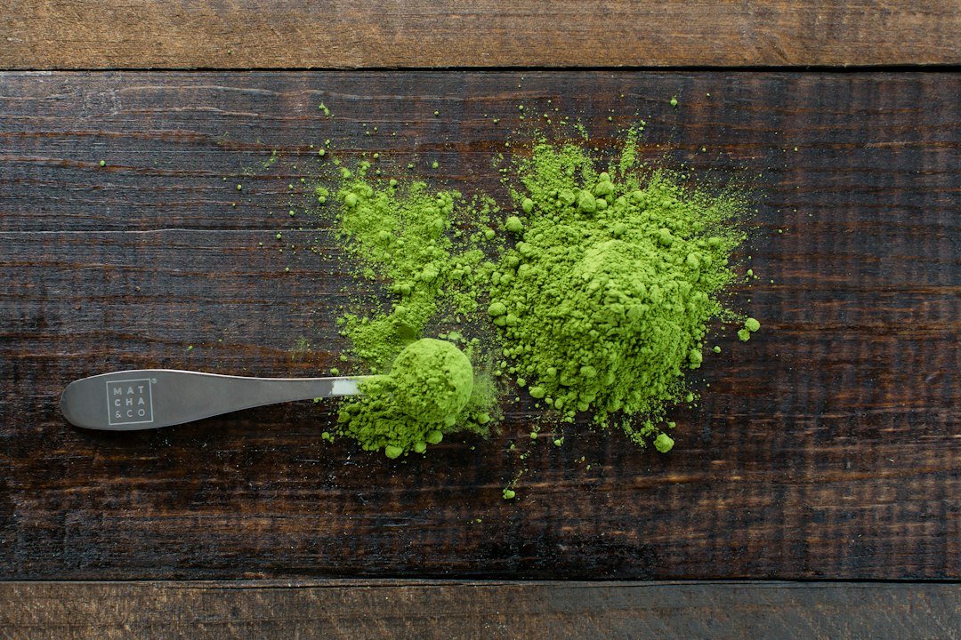 Finely ground green botanical powder with preparation tools